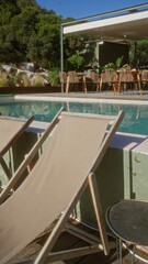 Sunlit poolside scene featuring empty deck chairs and an outdoor dining area with natural surroundings.
