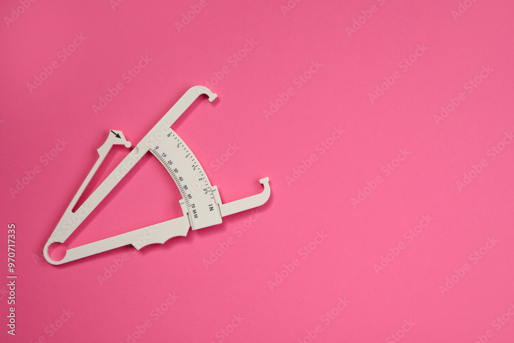 Canvas Prints Plastic body fat caliper on pink background, top view. Space for text