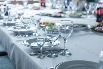 served table, glasses, plates, vase with forge