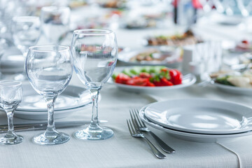 served table, glasses, plates, vase with forge