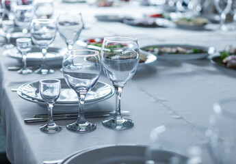 served table, glasses, plates, vase with forge