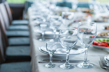served table, glasses, plates, vase with forge