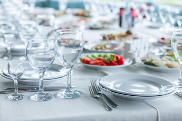 served table, glasses, plates, vase with forge