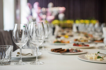 served table, glasses, plates, vase with forge