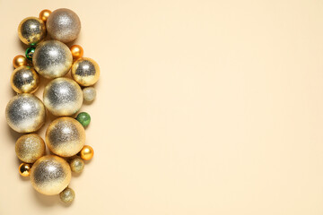 Christmas baubles on beige background, top view. Space for text