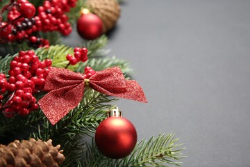 Fir tree branches with Christmas decor on grey background, closeup. Space for text