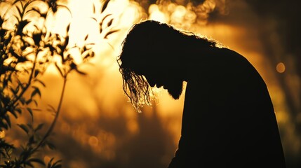 Naklejka premium Silhouette of jesus in deep prayer at gethsemane before betrayal and crucifixion scene