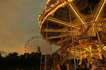 Amusement park in Novosibirsk, carousel with Ferris wheel.