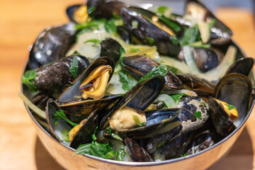 Delicious mussels, Cooked mussels with garlic and parsley, Fresh delicious mussels served in a restaurant in Belgium 