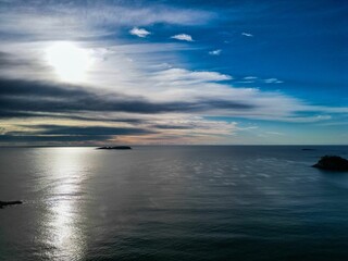 Serene seascape with sun and clouds