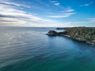 Aerial view of a serene coastline with clear blue waters.