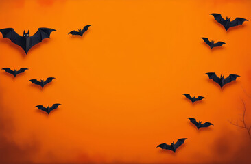 Fototapeta premium Black bats on an orange background. A Halloween postcard.