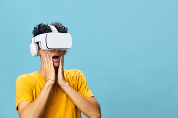 Virtual reality experience, surprised reaction, user with VR headset against a light blue...