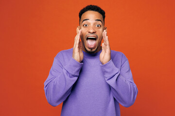 Young man of African American ethnicity wear purple sweatshirt casual clothes scream sharing hot...