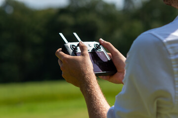 Smart controller, remote control of the drone, controller held in a man's hand, man controls the drone