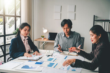 Young colleagues discussing financial business and analysis Teamwork concept in modern office Calculate personal taxes for clients