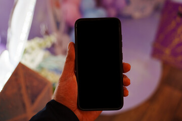 A man's hand with a phone. black screen.