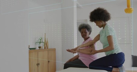 Animation of cardiographs over senior biracial woman exercising with female physiotherapist - Powered by Adobe