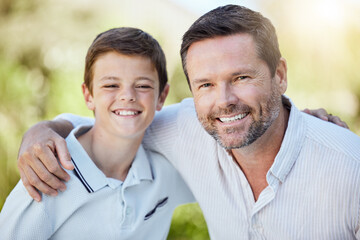 Obraz premium Portrait, happy and child with father in nature for bonding, travel and adventure on vacation. Outdoor, smile and boy with dad in park for connection on holiday, getaway or weekend trip in Australia