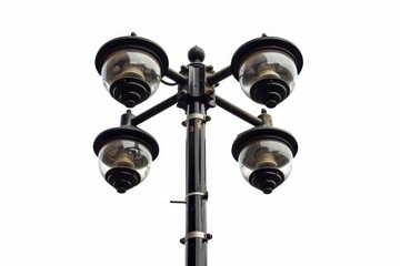 A lone street light stands tall on a utility pole against a bright white sky