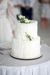Beautiful white cake decorated with flowers.