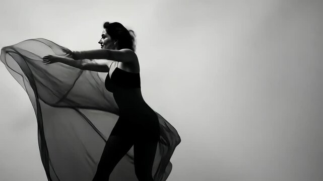 Graceful motion captured with flowing fabric in a black and white artistic expression