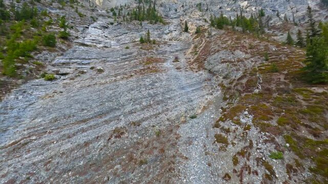 Ecological prehistoric limestone layers of etymology reveal rocky mountain peak with 15 out 20 uncommon stones found on cliffs closeup drone flyover 4k 4-4