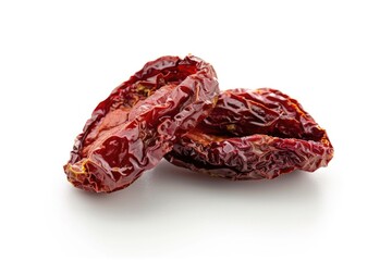 Obraz premium Close-up view of two dried tomatoes placed on a white surface