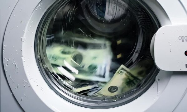 spinning money washing in washing machine. dollar spin inside the laundry machine.