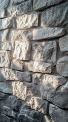 Fototapeta premium Rough textured stone wall in natural light