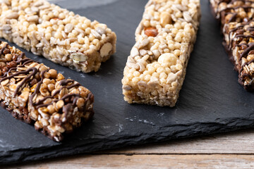 Healthy Muesli bar with nuts and seeds on wooden table