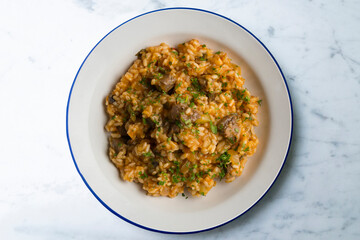 Rice paella with Iberian pork cheek. Top view table.