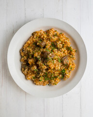 Rice paella with Iberian pork cheek. Top view table.