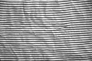 Processed collage of abstract black and white stripped cloth background with many folds