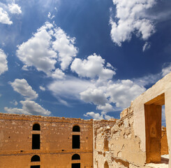 Qasr Kharana (Kharanah or Harrana)-- desert castle in eastern Jordan (100 km of Amman). Built in 8th century AD to be used as caravanserai, a resting place for traders. Against the sky with clouds