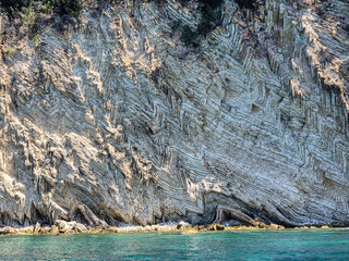 Outcrop of folded carbonate sedimentary rock at the coast in southern Albania