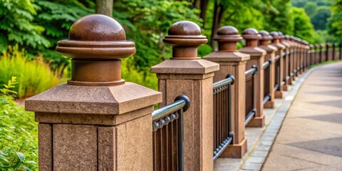 Naklejka premium Brown concrete post caps sit atop cement pillars, braced by metal railings, complementing the rustic beauty of the