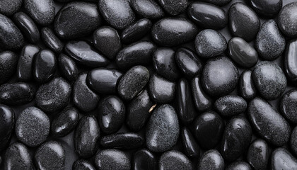 Smooth wet pebbles, texture background. Sea or ocean shore beach. Top view.