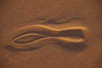 Footprint in the sand with intricate patterns