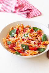 Pasta penne alla arrabiata with tomatoes, basil and parmesan cheese. Healthy Eating. Vegetarian Food.