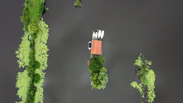 Island Lake Cabins At Scheendijk In The Loosdrecht Lakes, The Netherlands. Aerial Orbiting Shot
