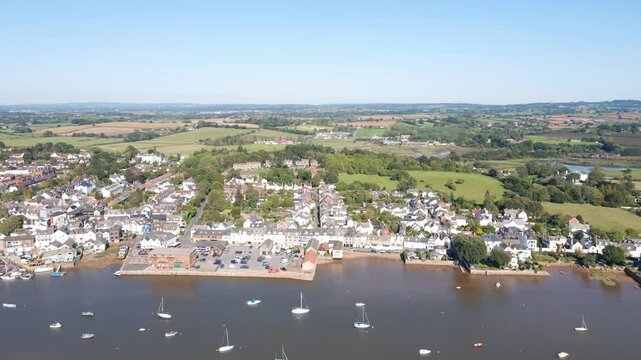 Aerial view of Topsham, Devon, highlights the River Exe and town. Captures the vibrant community, scenic riverside, and urban charm. Perfect for travel and cultural documentaries.