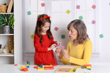 Fototapeta premium Proper articulation therapy for girl . Cute little child at speech therapist office