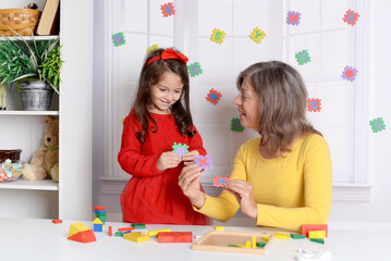 Proper articulation therapy for girl . Cute little child  at speech therapist office