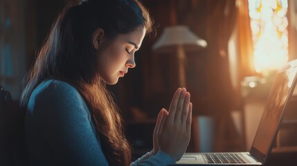 Woman praying by faith with computer laptop Church services online concept Online church at home concept spirituality and religion.