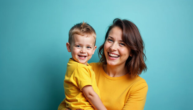 Woman in yellow clothes have fun posing with cute child baby boy 4-5 years old. Mommy little kid son isolated on blue background studio portrait. Mother's Day love family parenthood childhood concept.