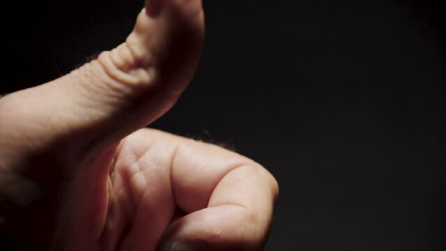 American Quarter Flicked From Man's Thumb in Close-Up