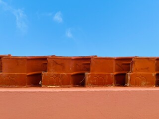 House wall, view towards blue sky, roof tiles 