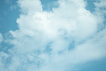 White cumulus clouds on a blue sky on a summer day.