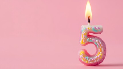 Burning birthday candle on pink background: number 5